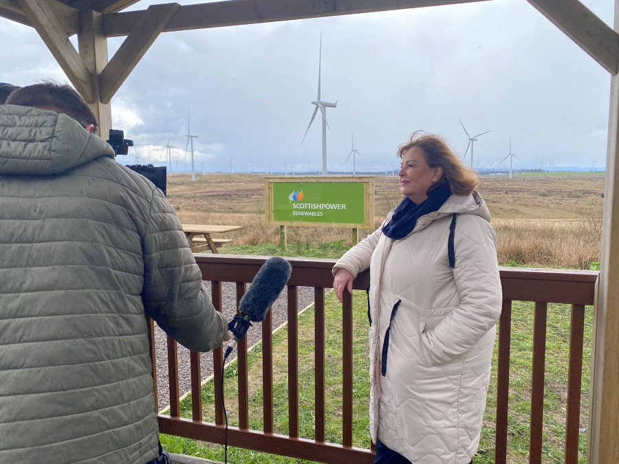 Deputy Convener Fiona Hyslop is interviewed by a journalist at Whitelee onshore windfarm.